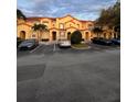 View of townhouses with red tile roofs, offering convenient parking and a community feel at 5290 Paradise Cay Circle, Kissimmee, FL 34746