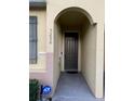 Inviting entrance with a covered entryway leading to the front door, ensuring protection from the elements at 5290 Paradise Cay Circle, Kissimmee, FL 34746