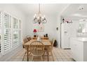 Cozy dining area with natural light and a charming chandelier at 5940 Chesapeake Park, Unit # 47, Orlando, FL 32819