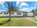 Charming single-story home featuring a well-maintained lawn and inviting curb appeal at 7416 Kadel Way, Orlando, FL 32822