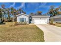 Charming single-story home with a well-manicured lawn and attached two-car garage at 7651 Sw 74Th Loop, Ocala, FL 34481