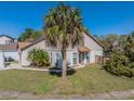 Inviting two-story home with lush landscaping and a well-manicured lawn under a clear blue sky at 7861 Copperfield Ct, Orlando, FL 32825