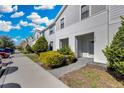 Townhouse exterior featuring a well-maintained lawn and inviting covered entrance at 8907 Sydney Ave, Kissimmee, FL 34747