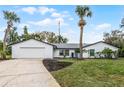 Charming single story home with a two car garage, nicely landscaped yard and mature palm trees at 8908 Turnberry Ct, Orlando, FL 32819