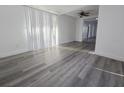 Bright and airy living room boasts new floors and natural light from large windows at 11618 Churchill St, Orlando, FL 32817