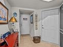 Welcoming entryway featuring tiled flooring, storage furniture and classic decor at 1206 Bella Cara Ct, Davenport, FL 33896