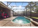 Screened-in pool area with brick pavers and a tranquil setting at 13711 Dornoch Dr, Orlando, FL 32828