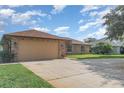 Charming single-story brick home featuring a spacious two-car garage at 1644 Piccadilly Dr, Daytona Beach, FL 32117