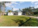 Single-story home on a lush lawn featuring a paved driveway and an attached two-car garage at 1959 9Th Ave, Deland, FL 32724