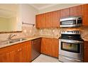 Kitchen featuring stainless steel appliances and wooden cabinetry at 206 E South St # 1018, Orlando, FL 32801