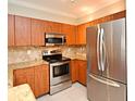 Well-equipped kitchen featuring stainless steel appliances and wooden cabinetry at 206 E South St # 1018, Orlando, FL 32801