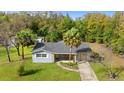 The home features a cozy front porch and well-maintained lawn at 20639 Sw Rainbow Lakes Blvd, Dunnellon, FL 34431