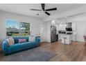 Open-concept living space featuring a modern kitchen, comfortable seating, and a welcoming atmosphere at 212 Oakland Ave, Sanford, FL 32773