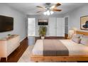 This main bedroom boasts hardwood floors, a ceiling fan, closet, and large windows that provide great natural light at 2722 Dodds Ln, Kissimmee, FL 34743