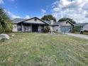Inviting one-story home featuring a spacious front yard with a decorative fountain at 2831 S M U Blvd, Orlando, FL 32817
