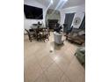 Open living room with a stone fireplace, tile flooring, and comfortable furniture at 2831 S M U Blvd, Orlando, FL 32817
