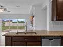 Modern kitchen with granite countertops, stainless steel appliances, and an open view to the backyard at 359 Quarry Rock Cir, Kissimmee, FL 34758