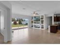 Spacious living room with built-in shelving, large windows, and tile flooring at 359 Quarry Rock Cir, Kissimmee, FL 34758