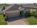 Beautiful single-story home featuring a well-manicured lawn, brick driveway, and cozy front entrance at 3797 Briarwood Estates Cir, St Cloud, FL 34772