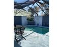 A view of the screened pool and patio area with comfortable seating, a flamingo statue, and sun protection at 4938 Samoa Cir # 6, Orlando, FL 32808