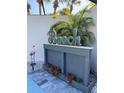 A beautifully decorated pool area featuring 'Beach' sign, tropical plants, and a decorative flamingo at 4938 Samoa Cir # 6, Orlando, FL 32808