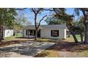 Well-maintained single-story home with lush trees, a spacious driveway and charming curb appeal at 509 Nicole Blvd, Ocoee, FL 34761