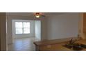 Bright living room boasts tile flooring, natural light, and an open layout at 5479 Vineland Rd # 9104, Orlando, FL 32811