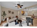 Cozy living room features neutral tones, a modern ceiling fan, stylish furniture and view into the kitchen at 911 N Orange Ave # 104, Orlando, FL 32801