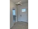 A bright foyer with neutral walls and a modern light fixture creates a welcoming entrance at 917 Swallow St, Deltona, FL 32725