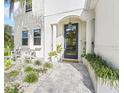 Inviting front entrance with modern glass door, stylish planters, and a charming seating area at 10236 Chorlton Cir, Orlando, FL 32832