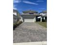 Detached two-car garage showcasing a paved driveway, solar panels and a neatly kept backyard at 11137 Lore Way, Orlando, FL 32832