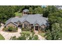 Luxury home with sprawling landscaped grounds, and a pool area visible in the background at 1500 Whitstable Ct, Lake Mary, FL 32746