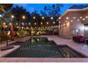 Relaxing backyard with a sparkling pool, spa, mature landscaping, and patio furniture, ideal for entertaining at 1500 Whitstable Ct, Lake Mary, FL 32746