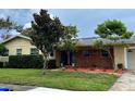 Beautiful single-story home showcasing a brick accent wall and colorful front garden at 1511 Leeway Ave, Orlando, FL 32810