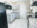 Updated kitchen with granite countertops, modern appliances, and ample cabinet space at 1511 Leeway Ave, Orlando, FL 32810