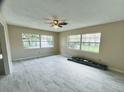 Spacious living room featuring tile flooring, neutral walls, large windows and a ceiling fan at 1511 Leeway Ave, Orlando, FL 32810