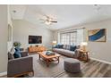 Cozy living room with vaulted ceiling, hardwood floors, neutral paint, ceiling fan and stylish contemporary furniture at 2169 Webster Ct, Deltona, FL 32738