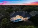 Aerial view of a beautiful home with a pool, spa, and manicured backyard at 2207 Cairns Ct, Orlando, FL 32835
