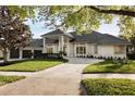 Beautiful home exterior with a stone driveway, lush green lawn, and three-car garage at 2207 Cairns Ct, Orlando, FL 32835