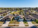 An aerial view of the property nestled in a quiet neighborhood with manicured lawns at 2665 Rotherham Rd, Tavares, FL 32778