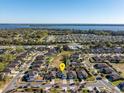 High-angle aerial showcasing a serene neighborhood with a lake view and a pin highlighting the property's location at 2665 Rotherham Rd, Tavares, FL 32778