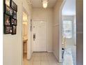 Welcoming entryway with tile flooring, coat hooks, and decor at 2706 Bushman Dr, Kissimmee, FL 34746