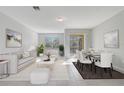 Bright and airy living room and dining area featuring neutral tones and access to the outdoor space at 2725 Econ Landing Blvd, Orlando, FL 32825