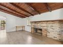 Living room features wood ceiling, fireplace, light wood flooring, and a large window at 27630 Jean Ave, Paisley, FL 32767