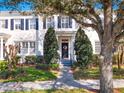 Traditional home with blue shutters, mature tree, and well-maintained landscaping, offering curb appeal at 2979 Upper Park Rd, Orlando, FL 32814