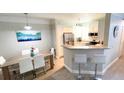 Modern kitchen featuring stainless steel appliances, a breakfast bar, and an adjacent dining area at 3000 Limbo Ln # 102, Kissimmee, FL 34746