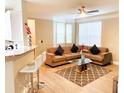 Inviting living room with a stylish sectional sofa, complemented by natural light and a ceiling fan at 3000 Limbo Ln # 102, Kissimmee, FL 34746