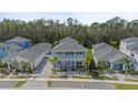 Spacious two-story home showcasing its manicured landscaping and proximity to lush greenery at 3114 Meleto Blvd, New Smyrna Beach, FL 32168