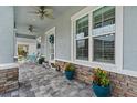 Charming front porch featuring decorative plants and stone accents on the home's exterior at 3114 Meleto Blvd, New Smyrna Beach, FL 32168