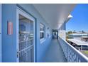 Hallway with neutral paint, balcony access and exterior facade at 315 N Causeway # B302, New Smyrna Beach, FL 32169